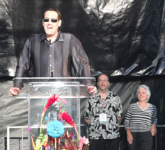 Stuart Milk speaking at the Pride rally in Balboa Park, Friday, July 16, 2010 with Larry Ramey and Judy Schaim (Pride co-chairs)