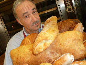 Charles Kaufman with an arm-full of his loaves from Bread & Cie
